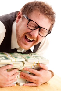 Man holding bundles of money - screaming, greed